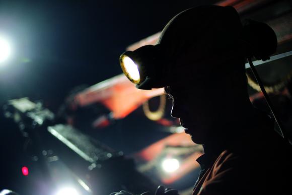 A drill rig operator at work on the service tunnel